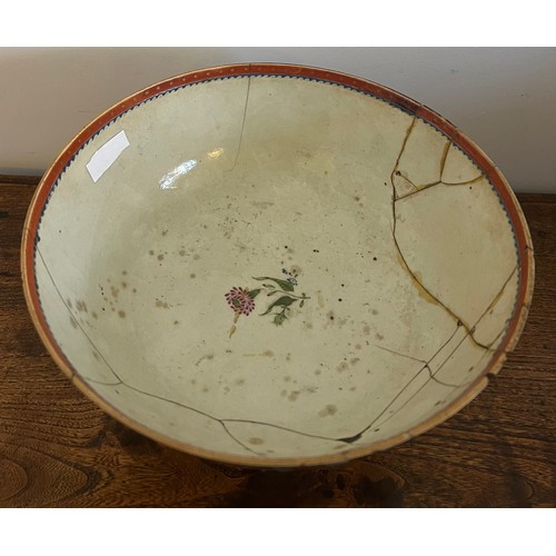 244 - An 18thC porcelain punch bowl 26cm d together with later wooden display stand. Purported to have be ... 