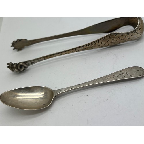 827 - French hallmarked sugar bows together with a bright cut teaspoon circa 1800. Weight 56gm.