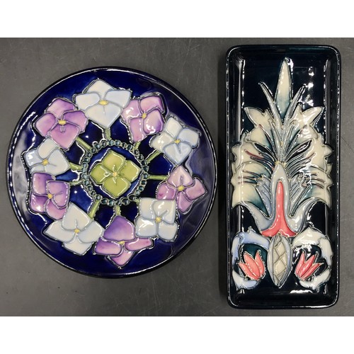 250 - Two Moorcroft pin trays one circular with blue, purple and green flower design 16cm d the other rect... 