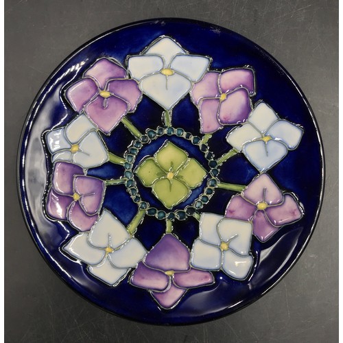 250 - Two Moorcroft pin trays one circular with blue, purple and green flower design 16cm d the other rect... 