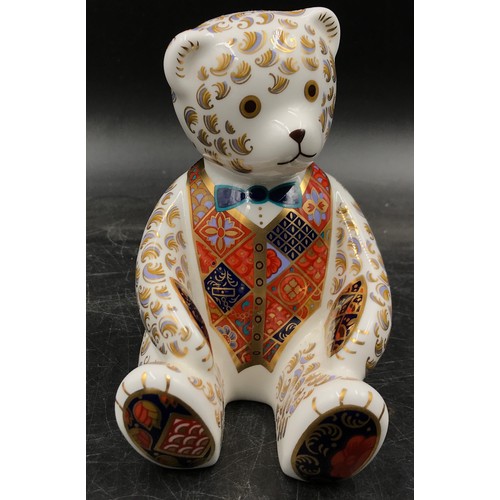 254 - A collection of royal crown derby to include Teddy Bear with blue bow tie paperweight with gold stop... 