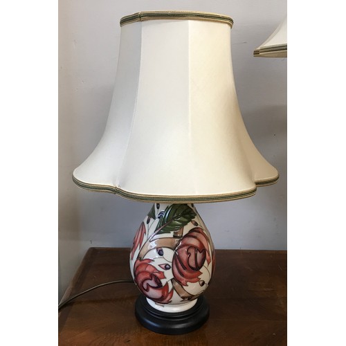 749 - Two matching Moorcroft table lamps with pink flower design tallest to top of shade 75cm.