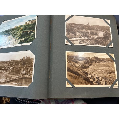 1289 - Two vintage postcard albums and contents to include views of Staithes, Whitby, Exeter, York, Filey, ... 