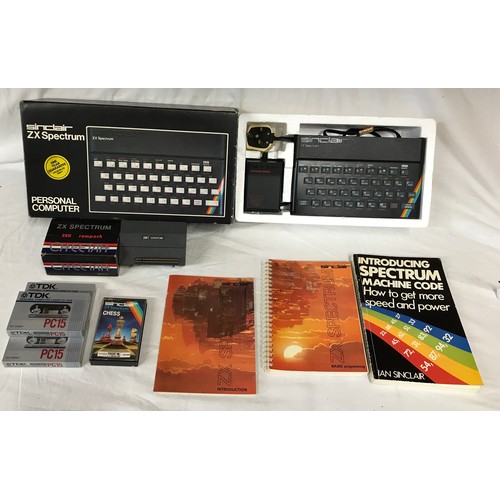 907 - A boxed Sinclair ZX Spectrum personal computer, with three books, a ZX Spectrum 32K rampack Cheetah,... 