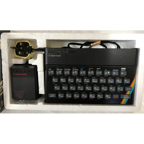 907 - A boxed Sinclair ZX Spectrum personal computer, with three books, a ZX Spectrum 32K rampack Cheetah,... 