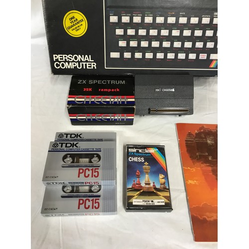 907 - A boxed Sinclair ZX Spectrum personal computer, with three books, a ZX Spectrum 32K rampack Cheetah,... 