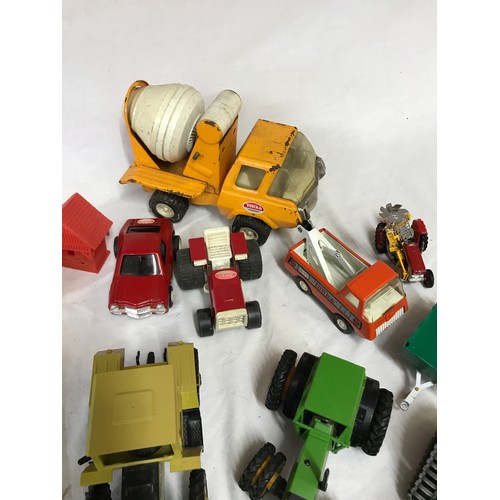 920 - A collection of toys to include four Tonka vehicles to include a cement mixer, tractor, tow truck an... 