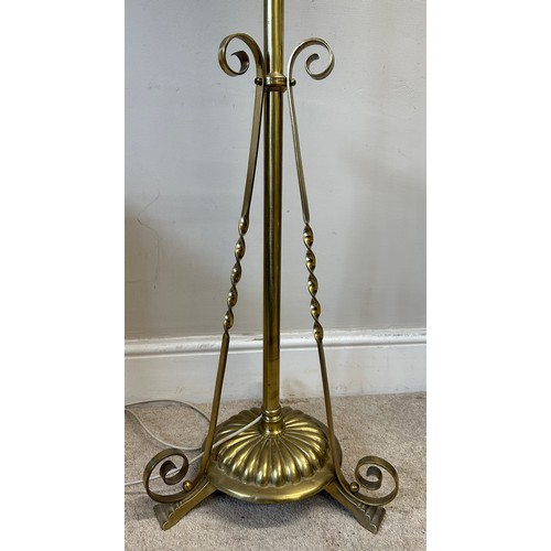 750 - A decorative scrolled brass standard lamp with shade converted from an oil lamp. 151cm h without fit... 