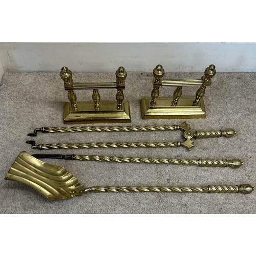 751 - A pair of brass fire dogs and associated irons.