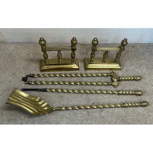 751 - A pair of brass fire dogs and associated irons.