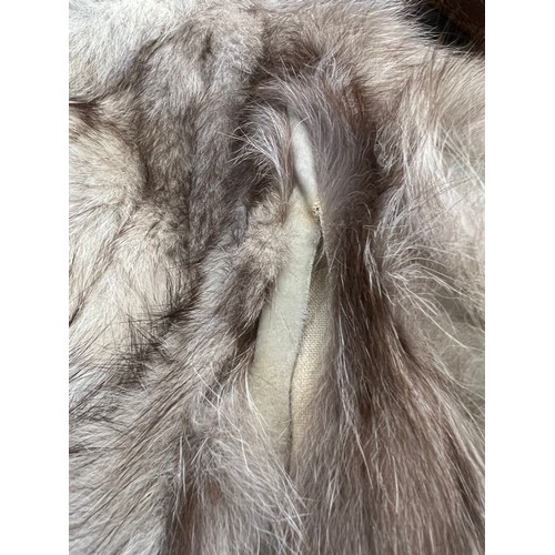 1056 - A vintage silver fox fur jacket. Nape to hem 74cm. Armpit to armpit 47cm.