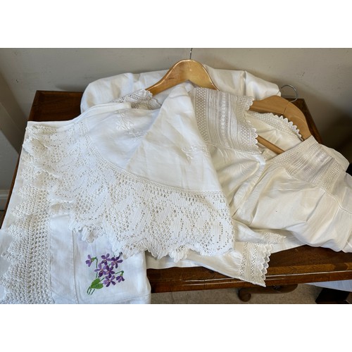 1058 - Two early 20thC cotton nightgowns and two small table cloths. Longest nightgown 120cm.