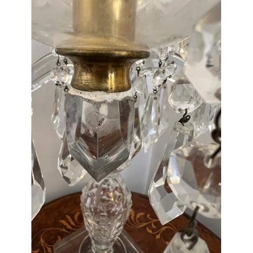 755 - A four branch glass candelabra with pendant lustre drops. 65cm h.