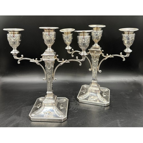 777 - A pair of good quality late 19thC silverplated twin branch candelabras with square bases decorated w... 