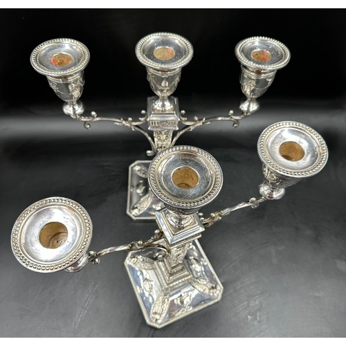 777 - A pair of good quality late 19thC silverplated twin branch candelabras with square bases decorated w... 