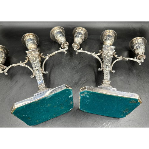 777 - A pair of good quality late 19thC silverplated twin branch candelabras with square bases decorated w... 