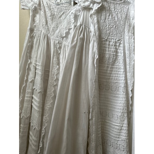 1061 - Five late 19thC/ 20thC christening gowns with panelled broderie anglaise together with an underskirt... 