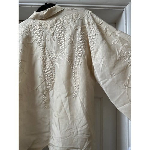 1068 - A cream vintage silk embroidered jacket with hand stitched wisteria decoration. Shoulder to hem 65cm... 