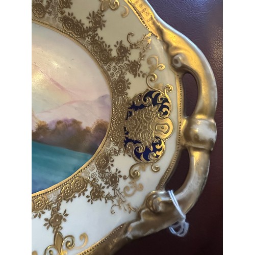 279 - Two Noritake dishes, one with gilt and lake scene  26.5 19cm and gilt and desert scene to the other.