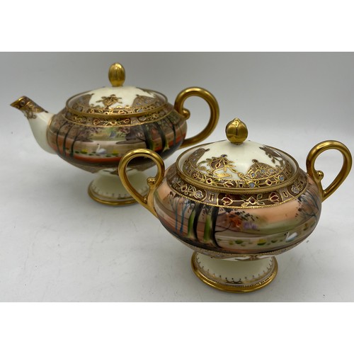 298 - A Nippon hand painted moriage teapot and lidded sucrier.