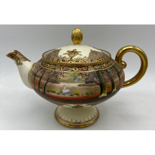 298 - A Nippon hand painted moriage teapot and lidded sucrier.