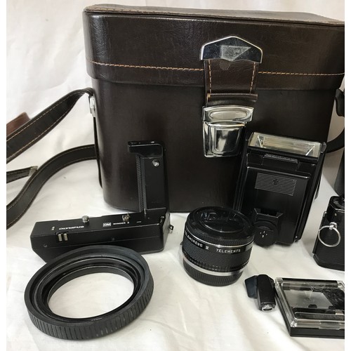 867 - A Olympus MD OM-1N camera with attached Zukio 28mm lens No.226311 along with a Vivitar series 1 70-1... 