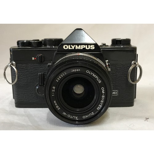 867 - A Olympus MD OM-1N camera with attached Zukio 28mm lens No.226311 along with a Vivitar series 1 70-1... 