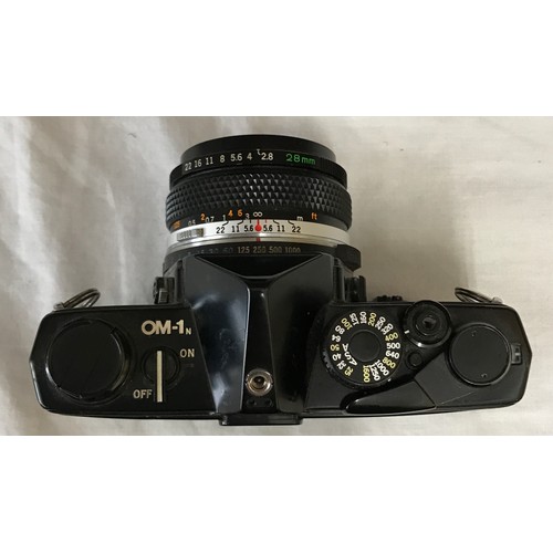 867 - A Olympus MD OM-1N camera with attached Zukio 28mm lens No.226311 along with a Vivitar series 1 70-1... 