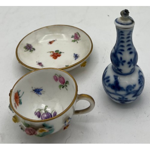 301 - A 19thC Meissen flower encrusted cup and saucer together with a Meissen blue and white onion pattern... 