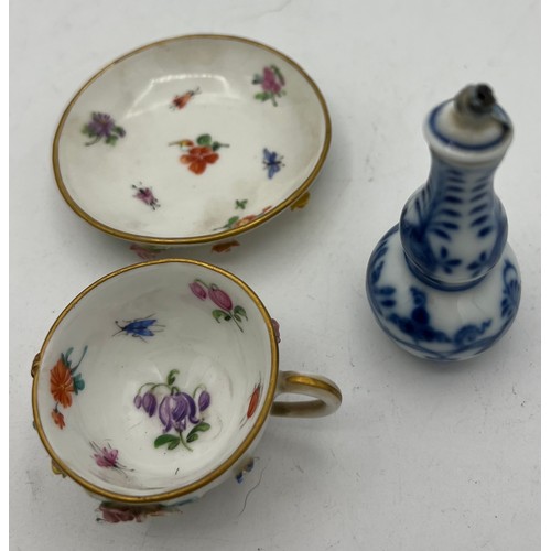 301 - A 19thC Meissen flower encrusted cup and saucer together with a Meissen blue and white onion pattern... 