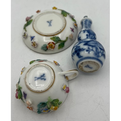 301 - A 19thC Meissen flower encrusted cup and saucer together with a Meissen blue and white onion pattern... 