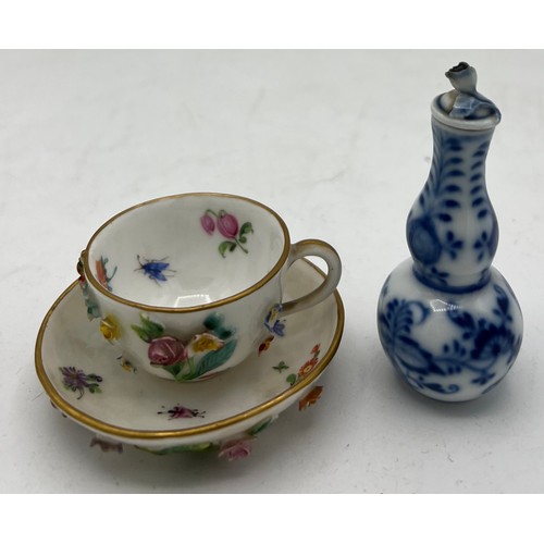 301 - A 19thC Meissen flower encrusted cup and saucer together with a Meissen blue and white onion pattern... 