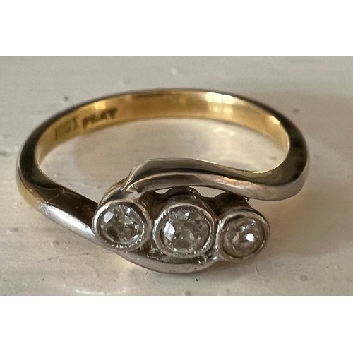 451 - An 18 carat gold and platinum ring set with three diamonds. Weight 3gm, size M.
