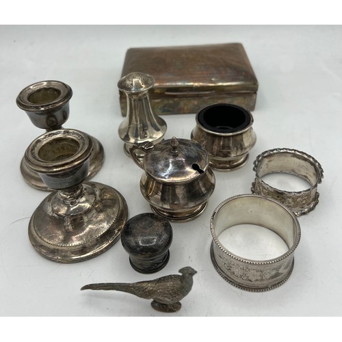 847 - A quantity of hallmarked silver to include two napkin rings, three piece cruet, weighted candlestick... 