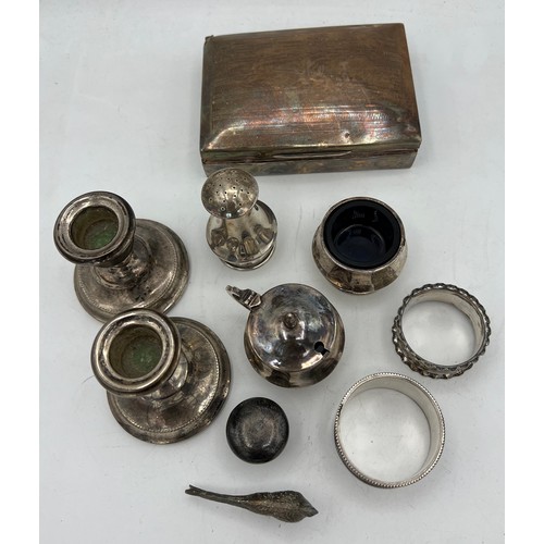 847 - A quantity of hallmarked silver to include two napkin rings, three piece cruet, weighted candlestick... 