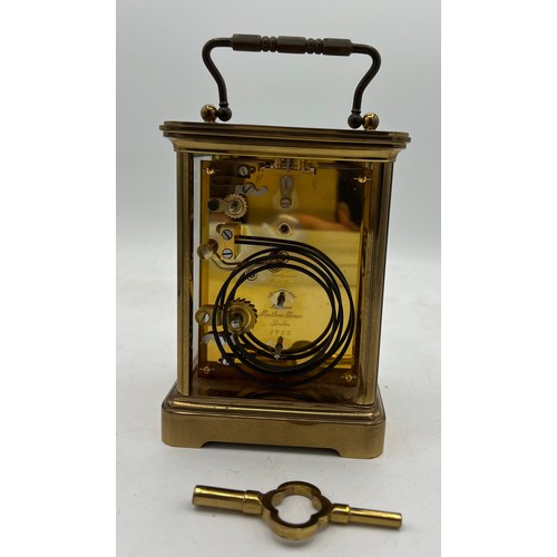 1032 - A Matthew Norman brass carriage clock with key. 13.5cm h without handle.