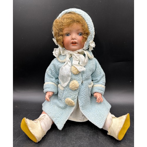 929 - An Armand Marseille 1330 bisque headed doll in vintage clothing with blue sleeping lashed eyes and t... 