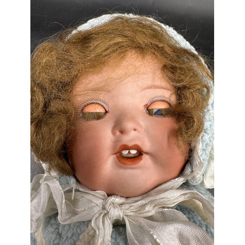 929 - An Armand Marseille 1330 bisque headed doll in vintage clothing with blue sleeping lashed eyes and t... 