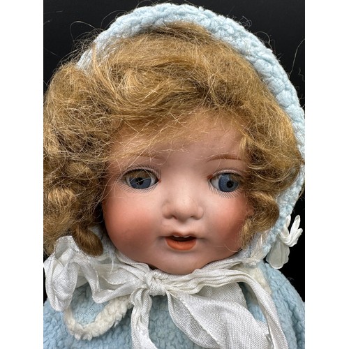 929 - An Armand Marseille 1330 bisque headed doll in vintage clothing with blue sleeping lashed eyes and t... 