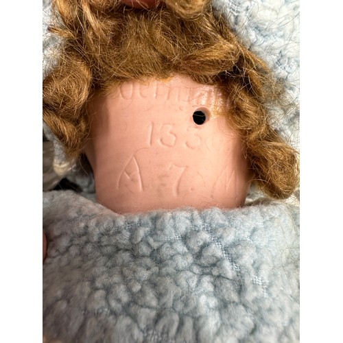 929 - An Armand Marseille 1330 bisque headed doll in vintage clothing with blue sleeping lashed eyes and t... 