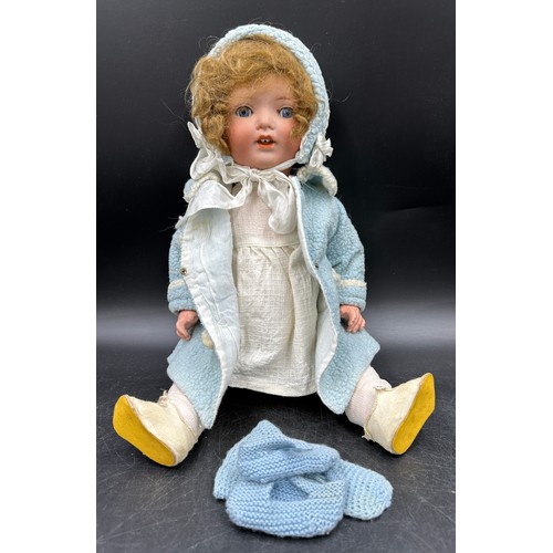 929 - An Armand Marseille 1330 bisque headed doll in vintage clothing with blue sleeping lashed eyes and t... 