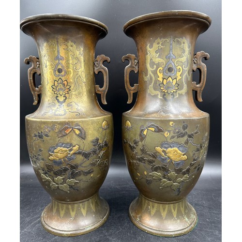 1010 - A pair of heavy decretive twin handled bronze vases relief cast in brass and other metals with birds... 