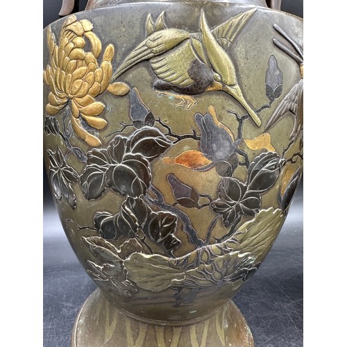 1010 - A pair of heavy decretive twin handled bronze vases relief cast in brass and other metals with birds... 