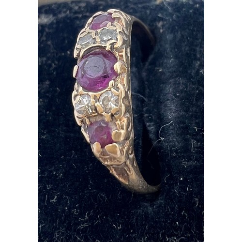 460 - A 9 carat gold ring set with garnets and diamonds. Size Q. Weight 1.9gm.