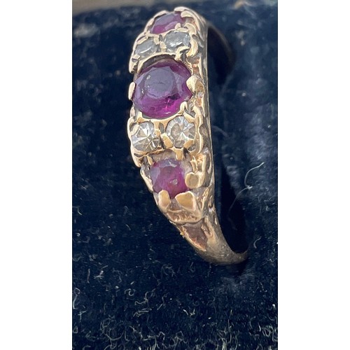 460 - A 9 carat gold ring set with garnets and diamonds. Size Q. Weight 1.9gm.