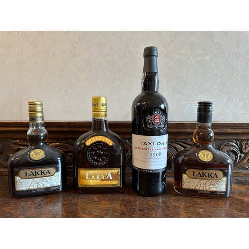 717 - A collection of bottles to include Taylor's 2008 vintage port and three Lakka cloudberry bottles.