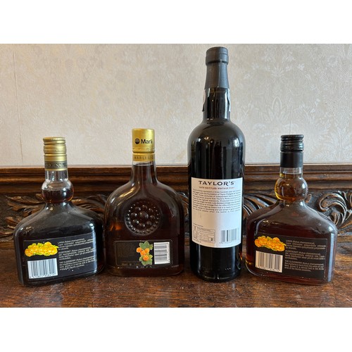 717 - A collection of bottles to include Taylor's 2008 vintage port and three Lakka cloudberry bottles.