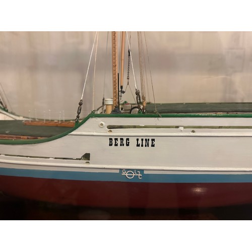 1215 - Model of Berg Line ship, J Scott, Goole in mahogany and glass. 59h x 121 w x 38cm d.