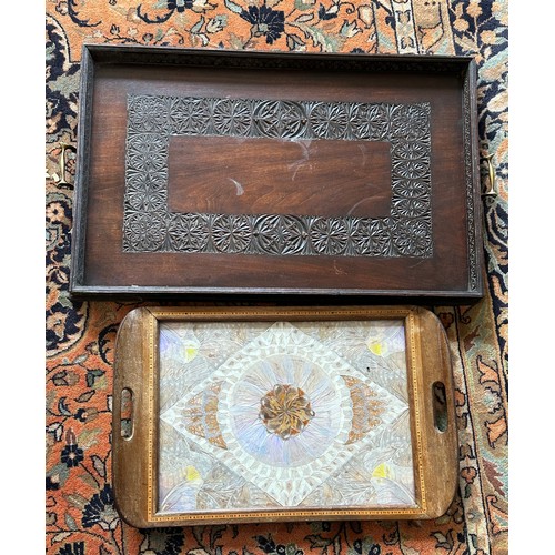 1216 - Two hardwood trays, one carved and one inlaid with butterfly wings. Largest 64 x 41cm without handle... 