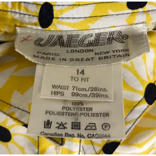 1076 - A Jaeger polyester matching top, skirt and hat decorated in flowers on a yellow background measuring... 